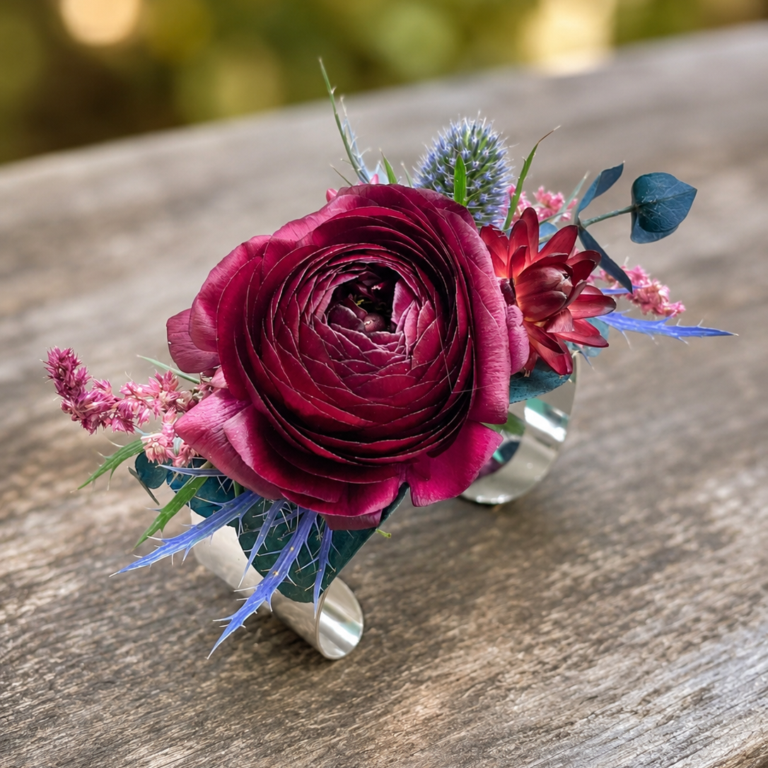 Burgundy ranunculus and navy wrist corsage for prom