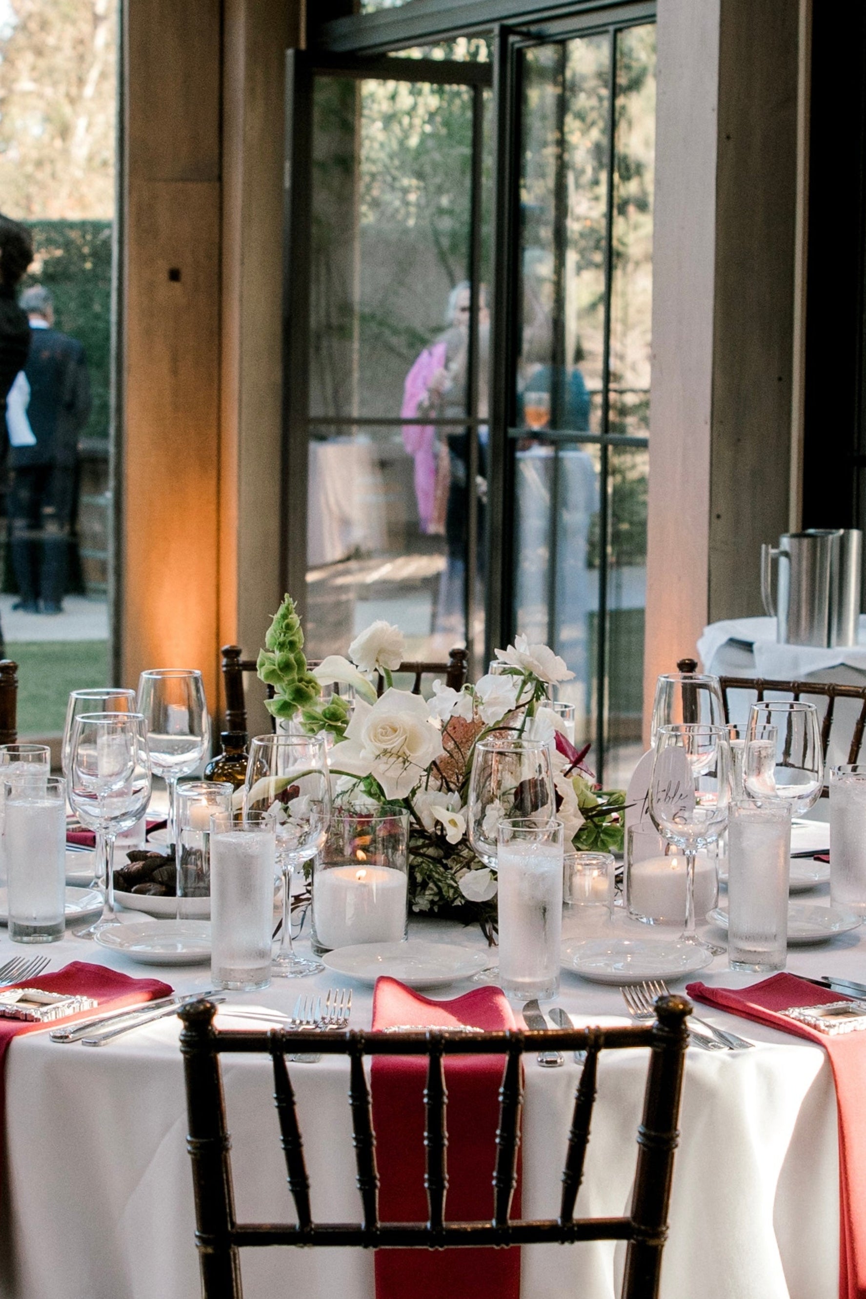 Floral meadow with pearled wax candles on a round wedding table at Calamigos Ranch