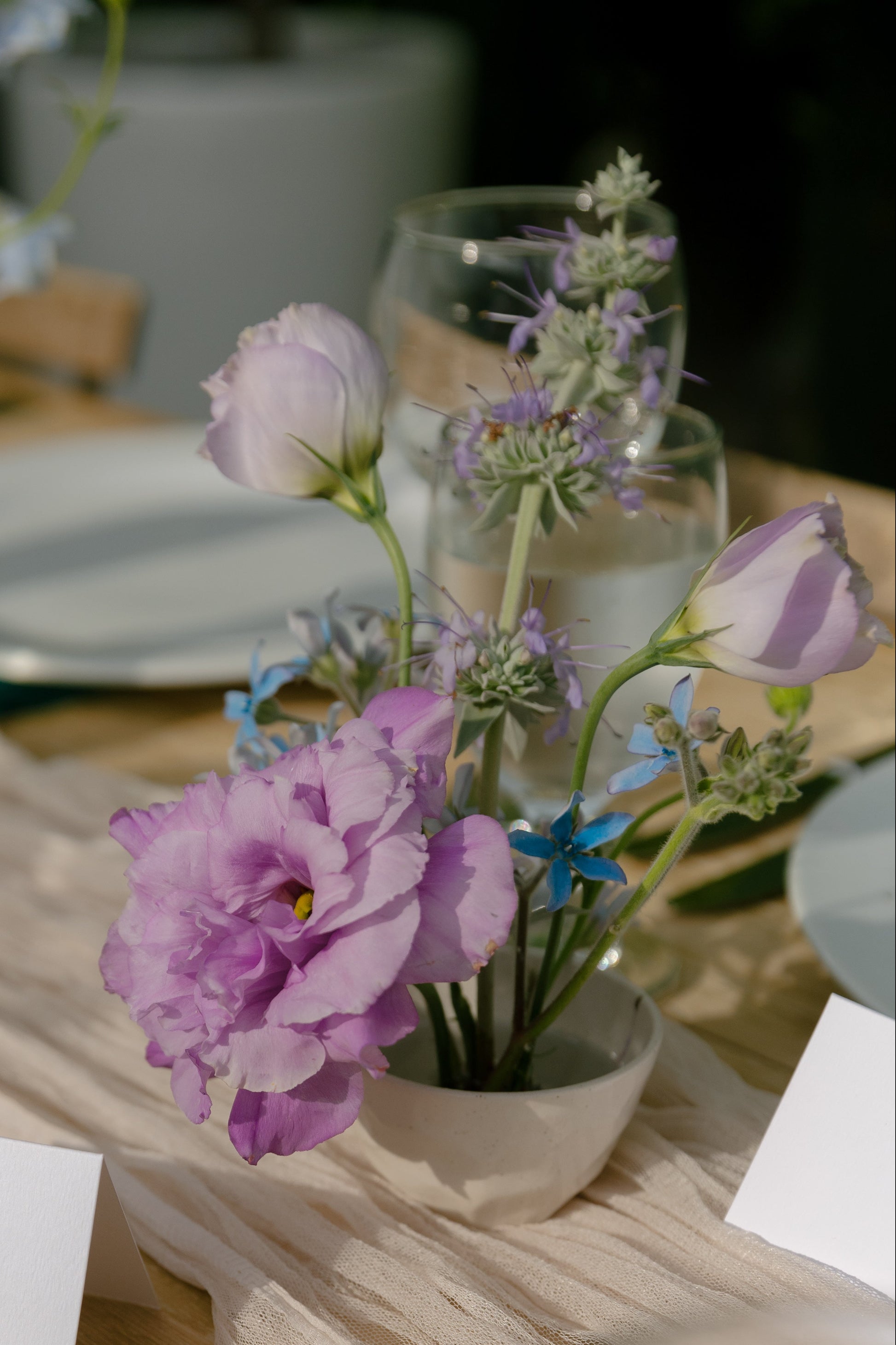 Ikebana floral arrangement in lavender and light blue.