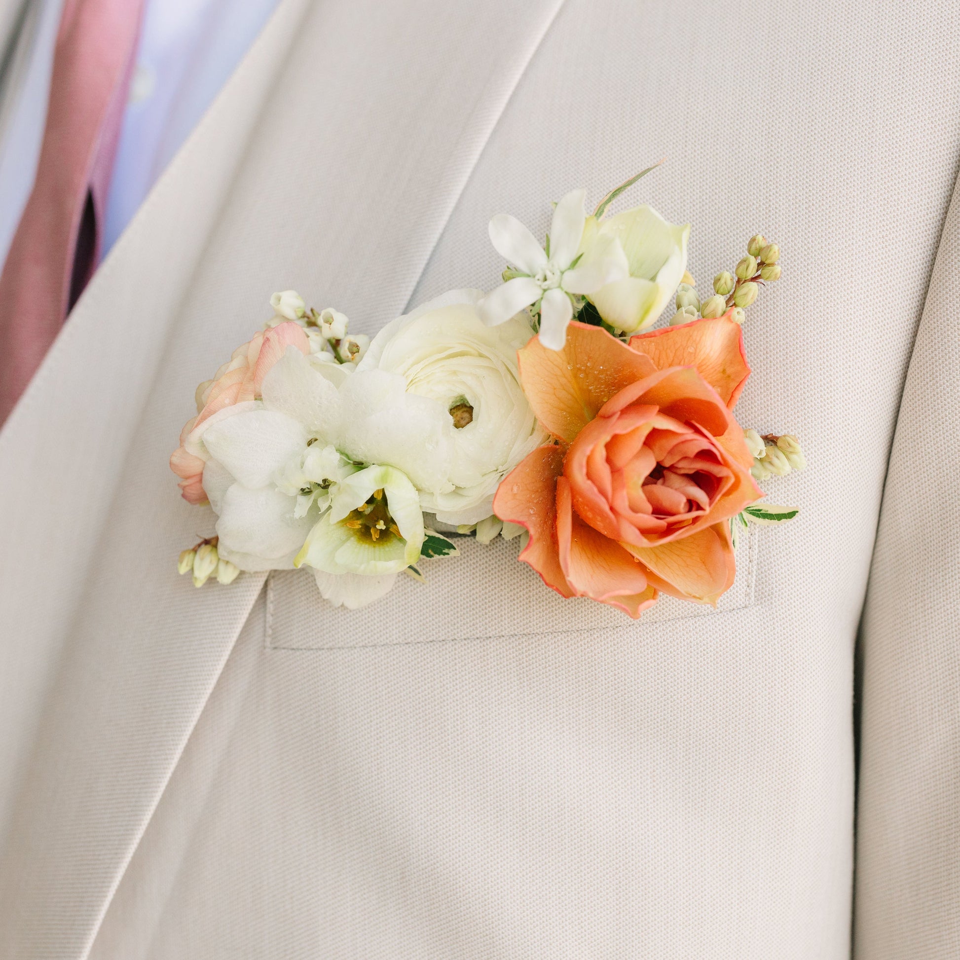 Pocket Square Boutonniere with a white ranunculus and peach spray rose