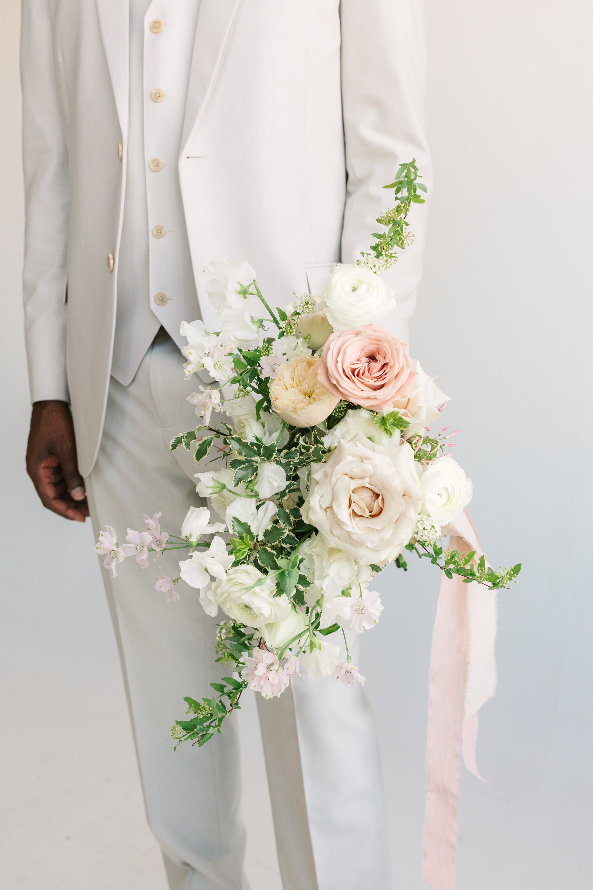 Premium neutral wedding bouquet held by model