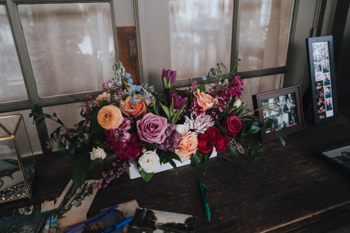 Shades of purple and peach long floral arrangement
