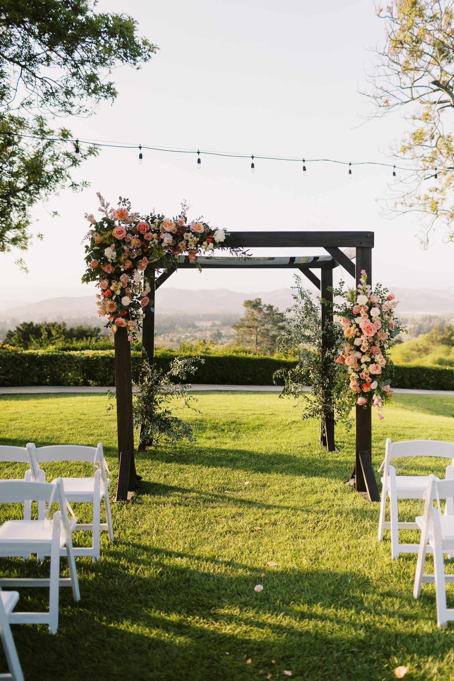 Dark Wood Chuppah with garden style flowers