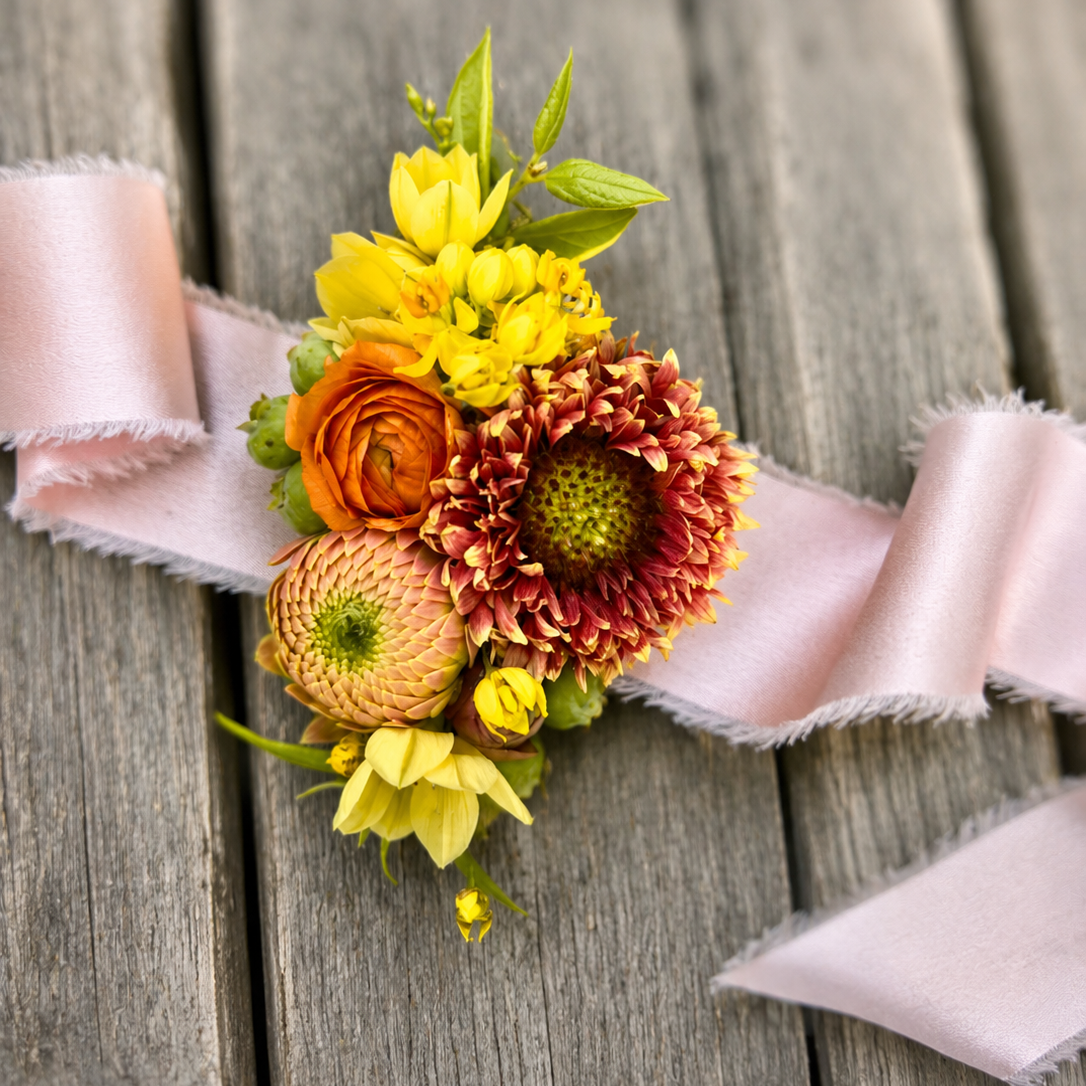 Floral corsage with blush ribbon