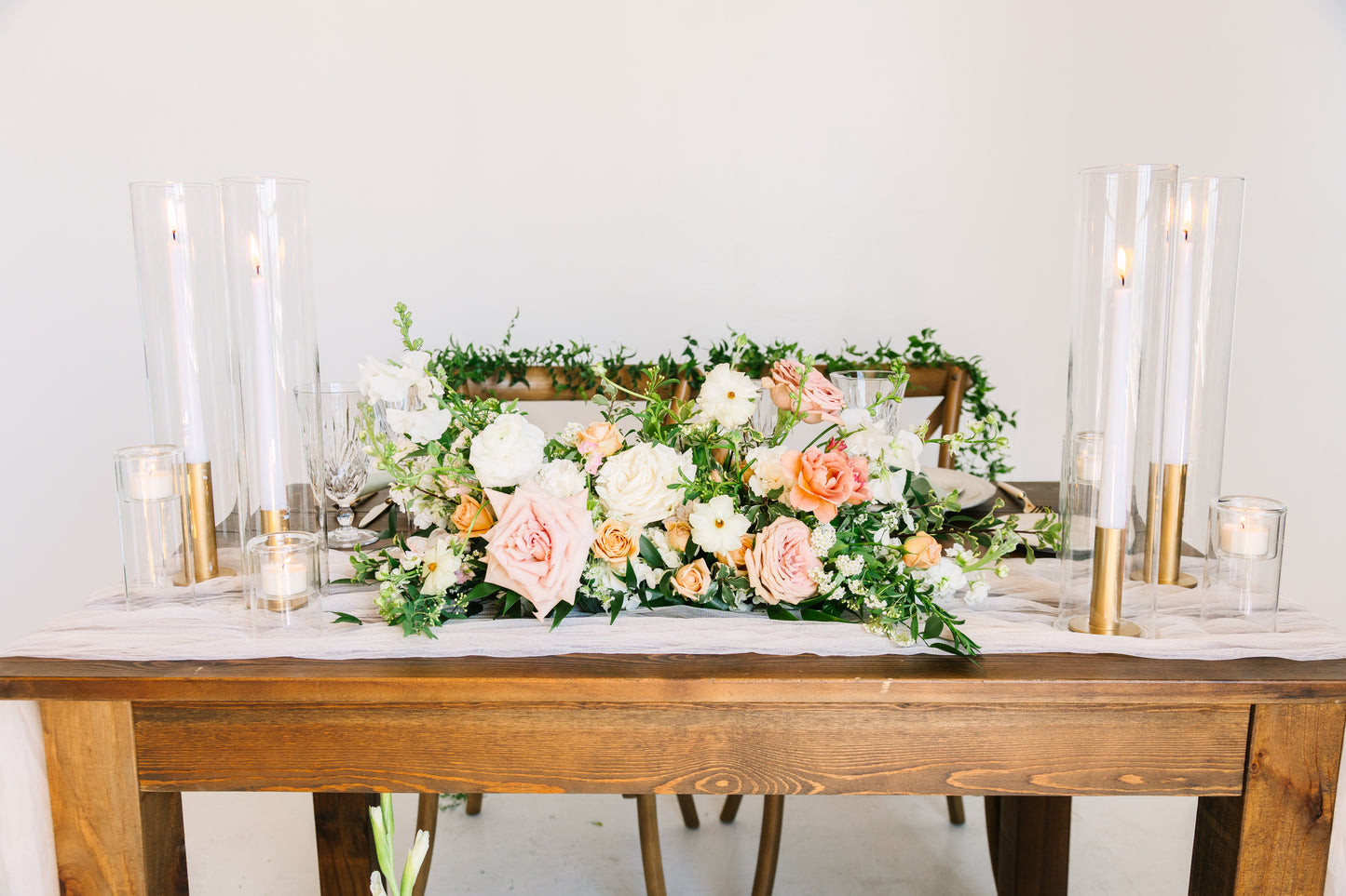 Sweetheart table floral spray with layered seasonal flowers