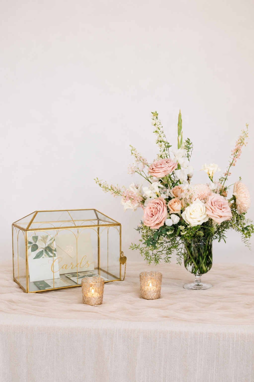 Welcome table floral arrangement with soft seasonal flowers