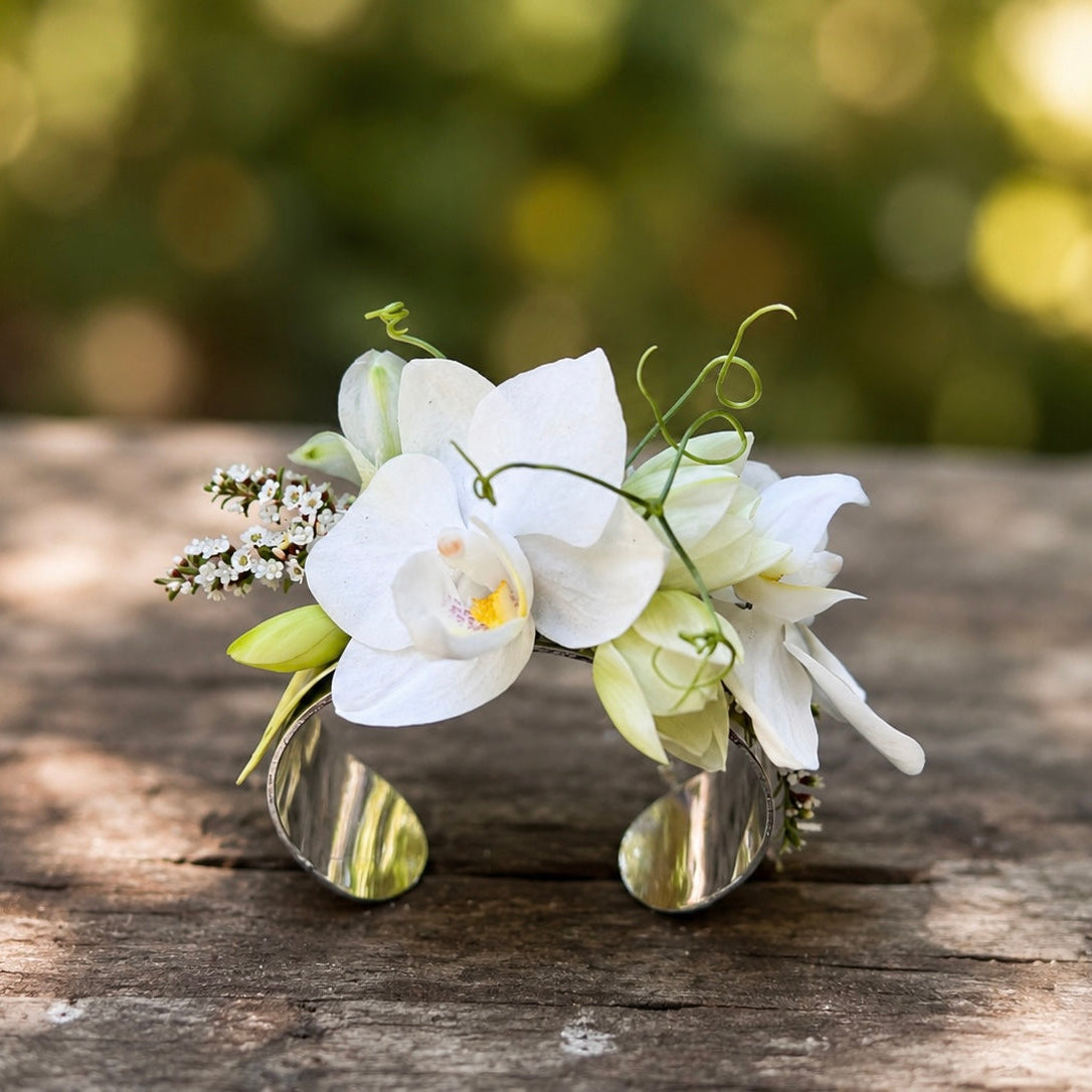 White Prom wrist corsage on a silver bracelet cuff with orchids